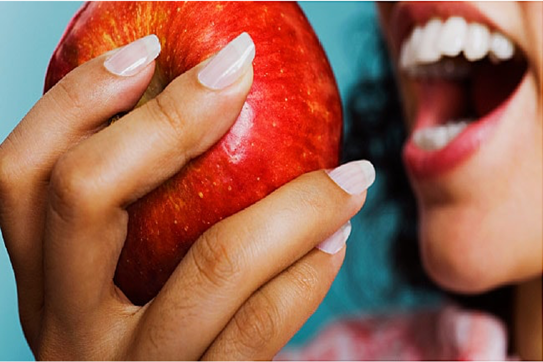 Close up women eating apple
