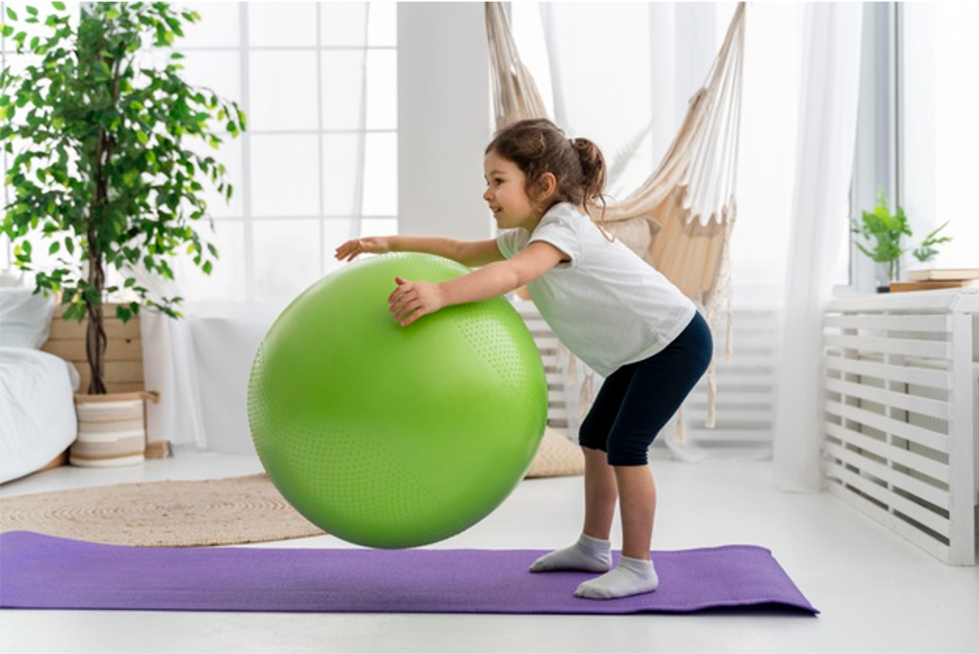 young child lime green yoga ball